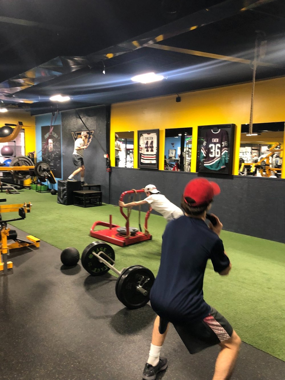 Athletes completing a coached sled drill at PowerPlay